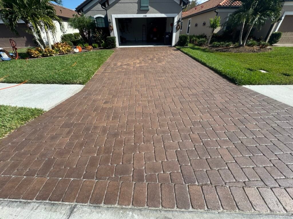 a brick driveway with a garage door