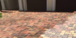 a brick patio with a door and a garage door